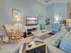 Cozy living room with comfortable seating and a calming blue color scheme at 117 Altesino Ct, Venice, FL 34292