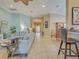 Open-concept living space flows into dining area, featuring comfortable seating, neutral tones, and modern design elements at 117 Altesino Ct, Venice, FL 34292