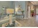 Comfortable living room featuring elegant furnishings, artwork, and seamless transition to the hallway and entry, radiating warmth at 117 Altesino Ct, Venice, FL 34292