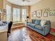 Bright office with a large bay window, hardwood floors, and a comfortable blue couch at 117 Altesino Ct, Venice, FL 34292