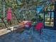Relax on this outdoor patio with wicker chairs, a glass table and tropical backyard views at 117 Altesino Ct, Venice, FL 34292