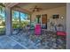 Relaxing screened-in patio features ample seating, a ceiling fan, and easy access to the interior at 117 Altesino Ct, Venice, FL 34292