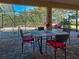 Enclosed patio with dining table set and chairs overlooks a private pool and lush landscaping at 117 Altesino Ct, Venice, FL 34292