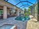 Screened-in pool with paved patio and outdoor seating area at 117 Altesino Ct, Venice, FL 34292