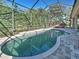 Sparkling screened-in pool with tiled edge and nearby seating at 117 Altesino Ct, Venice, FL 34292