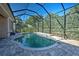 Private swimming pool surrounded by lush greenery and screened enclosure for year-round enjoyment at 117 Altesino Ct, Venice, FL 34292