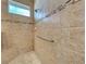 Detailed view of tiled shower with bench, grab bar, and glass accents at 117 Altesino Ct, Venice, FL 34292