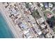 Aerial view of a home surrounded by neighboring properties and lush greenery in a coastal neighborhood at 1170 Little Ct, Englewood, FL 34223