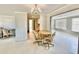 Bright dining area with chandelier, sliding doors, and view into other rooms at 1170 Little Ct, Englewood, FL 34223