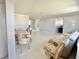 Bright living room featuring neutral tones and multiple seating areas at 1170 Little Ct, Englewood, FL 34223