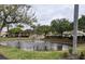 Scenic pond with a fountain, framed by mature trees and manicured lawns at 1204 L Pavia Blvd # 1204, Venice, FL 34292