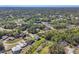 Expansive aerial shot showcasing the community's lush greenery, residential properties, and tranquil pond at 1207 Henning St, North Port, FL 34288