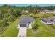 Aerial view of a house with a well-manicured lawn and landscaping at 1207 Henning St, North Port, FL 34288