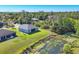 Scenic view of the backyard bordering a tranquil pond, offering a peaceful retreat and natural beauty at 1207 Henning St, North Port, FL 34288