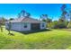 Expansive backyard featuring lush green grass, providing a serene outdoor space for relaxation and recreation at 1207 Henning St, North Port, FL 34288