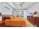An inviting bedroom features tray ceilings, a ceiling fan, neutral walls, and a large bed with decorative pillows at 1207 Henning St, North Port, FL 34288