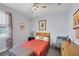 Comfortable bedroom with a ceiling fan, accent chair, and a bright window bringing the outdoors in at 1207 Henning St, North Port, FL 34288