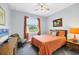 Cozy bedroom with a comfortable bed, ceiling fan, and bright window views of the backyard at 1207 Henning St, North Port, FL 34288