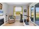 Bright room with a recliner chair, a television, an indoor exercise machine, and slider doors to the porch at 1207 Henning St, North Port, FL 34288