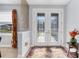 Bright foyer featuring decorative double doors, stylish wall decor, and a colorful area rug at 1207 Henning St, North Port, FL 34288