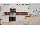 Detailed view of a modern kitchen, showcasing stainless steel appliances and granite countertops at 1207 Henning St, North Port, FL 34288