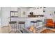 Modern kitchen with granite countertops, white cabinets, and bar seating with a stainless steel microwave at 1207 Henning St, North Port, FL 34288