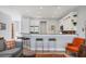 Open kitchen area with bar seating, stainless steel appliances, and modern white cabinetry at 1207 Henning St, North Port, FL 34288
