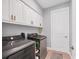Convenient laundry room featuring modern washer and dryer, ample storage, and easy access at 1207 Henning St, North Port, FL 34288