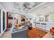 Bright living room with open bar and kitchen, decorative ceiling, and access to outdoor space at 1207 Henning St, North Port, FL 34288