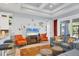 Cozy living room with decorative ceiling, a flat-screen TV, and bar seating at the kitchen counter at 1207 Henning St, North Port, FL 34288