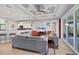 Open-concept living area with a view of the kitchen bar, large sliding doors and decorative ceilings at 1207 Henning St, North Port, FL 34288