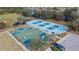 Aerial view of community basketball and shuffleboard courts next to playground and parking at 12127 Granite Woods Loop, Venice, FL 34292