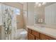 Updated bathroom featuring a shower-tub combo, cream vanity, and decorative shower curtain at 12127 Granite Woods Loop, Venice, FL 34292
