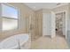 Bright bathroom with garden tub and separate glass shower at 12127 Granite Woods Loop, Venice, FL 34292
