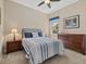 Bright bedroom with a queen bed, an accent picture, and wooden furniture at 12127 Granite Woods Loop, Venice, FL 34292