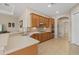 Bright kitchen with tile floor, wood cabinets, updated appliances, and a breakfast bar at 12127 Granite Woods Loop, Venice, FL 34292