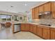 Beautiful kitchen with stainless steel appliances, tile backsplash and wood cabinets at 12127 Granite Woods Loop, Venice, FL 34292