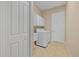 Convenient laundry room with white cabinets, washer, dryer, and tile flooring at 12127 Granite Woods Loop, Venice, FL 34292