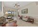 A cozy living room with tile floors, neutral decor, and lanai access at 12127 Granite Woods Loop, Venice, FL 34292
