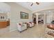 Open-concept living room featuring neutral paint, tile flooring, and access to other living spaces at 12127 Granite Woods Loop, Venice, FL 34292