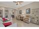Spacious living room with tile flooring, neutral paint, and multiple seating areas at 12127 Granite Woods Loop, Venice, FL 34292