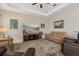 Relaxing living room with fan, decorative rug and a large TV at 12127 Granite Woods Loop, Venice, FL 34292