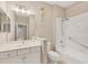 Bright bathroom featuring a white vanity, toilet, and shower/tub combination at 12198 Sebring Ln, Venice, FL 34293