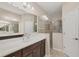 Bright bathroom featuring double sink vanity, large mirror, and glass enclosed shower at 12198 Sebring Ln, Venice, FL 34293