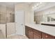 Bathroom featuring double sink vanity, tile floors, and walk-in shower at 12198 Sebring Ln, Venice, FL 34293