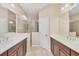 Bathroom featuring double sink vanity, tile floors, and walk-in shower at 12198 Sebring Ln, Venice, FL 34293