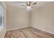 Empty bedroom featuring wood floors, a ceiling fan, and natural light at 12198 Sebring Ln, Venice, FL 34293