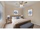 Staged bedroom featuring a ceiling fan, natural light, and pleasing decor at 12198 Sebring Ln, Venice, FL 34293
