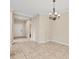 Traditional dining room with tile floors, chandelier, and open doorway at 12198 Sebring Ln, Venice, FL 34293