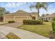 Charming single-story home with a tile roof, well-manicured lawn, and a two-car garage at 12198 Sebring Ln, Venice, FL 34293